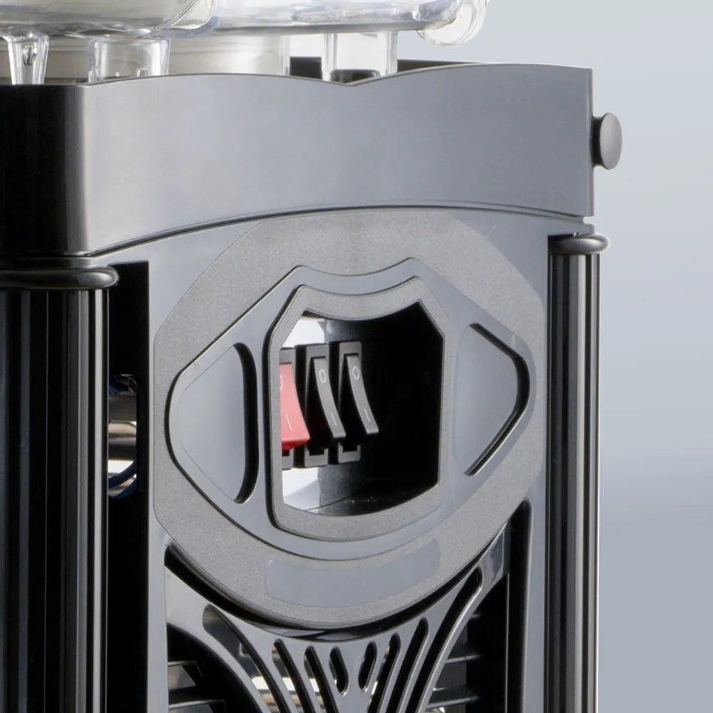 Close-up of a metallic device with a geometric design on a light gray background