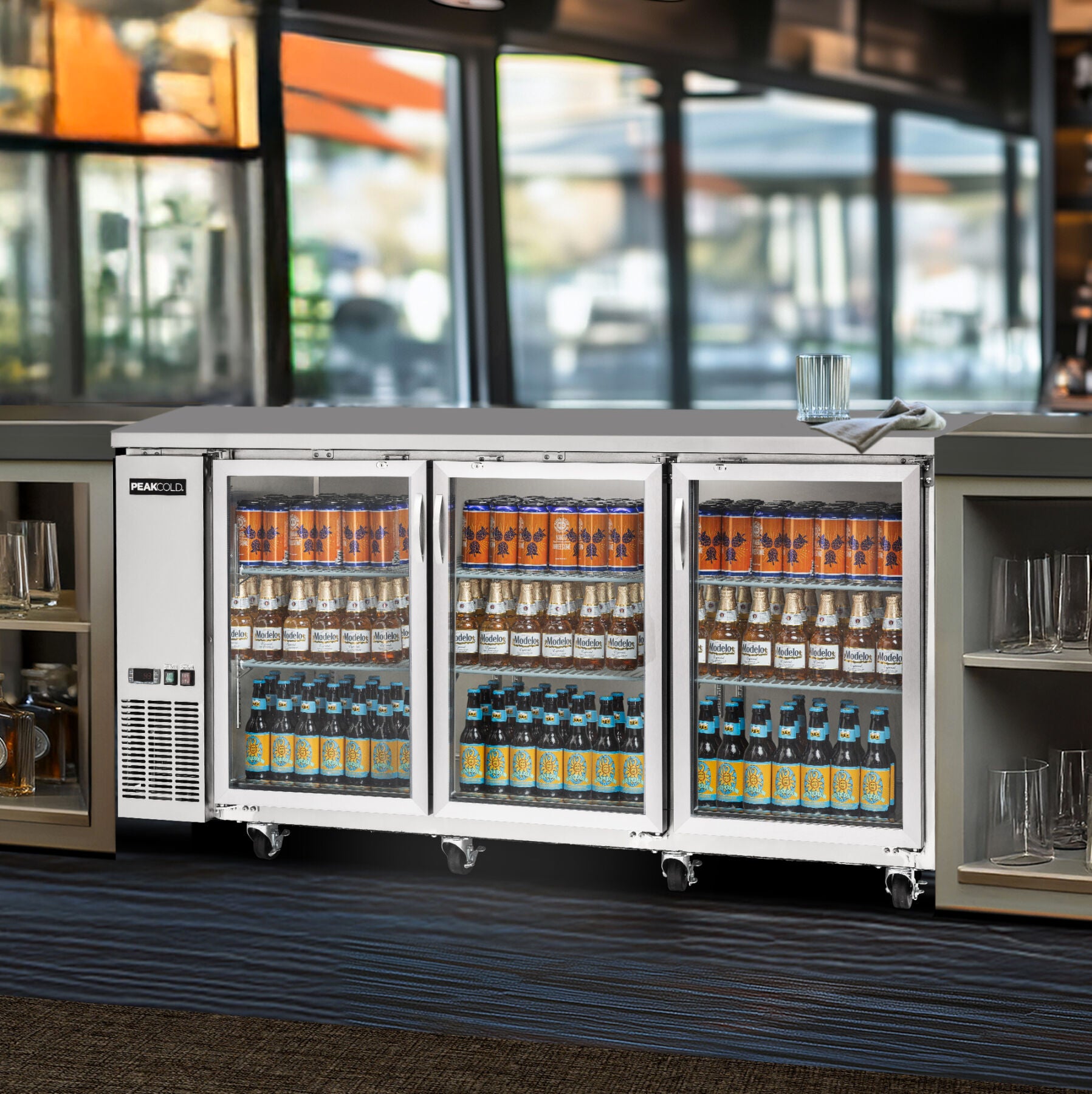 Commercial refrigerator stocked with beverages in a bar setting