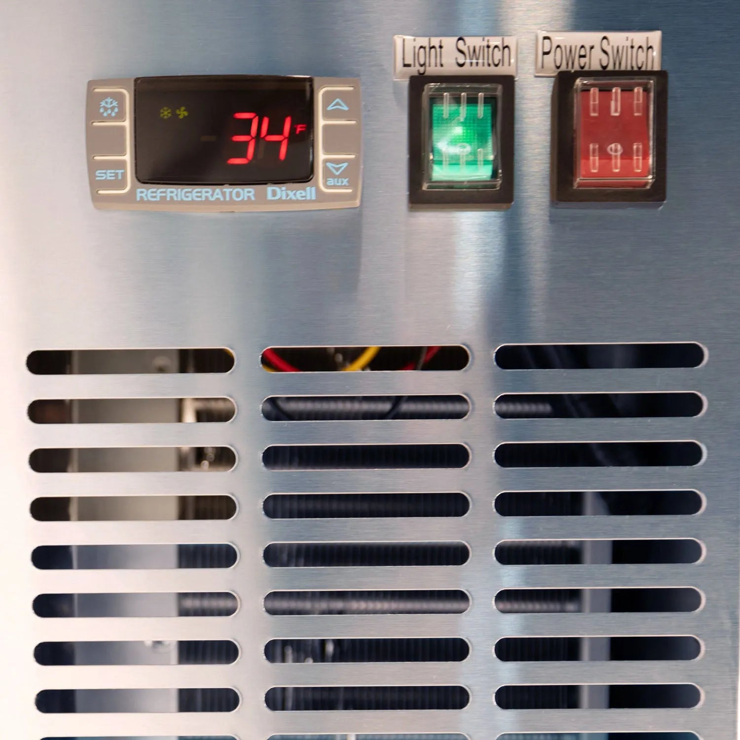 Control panel with digital display, light switch, and power switch on a metallic surface.