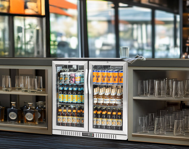 Beverage cooler with drinks and glasses in a bar setting