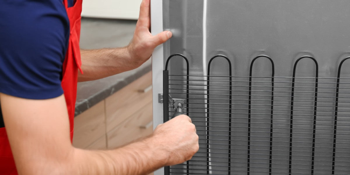 Dirty commercial refrigerator condenser coils being cleaned for better energy efficiency