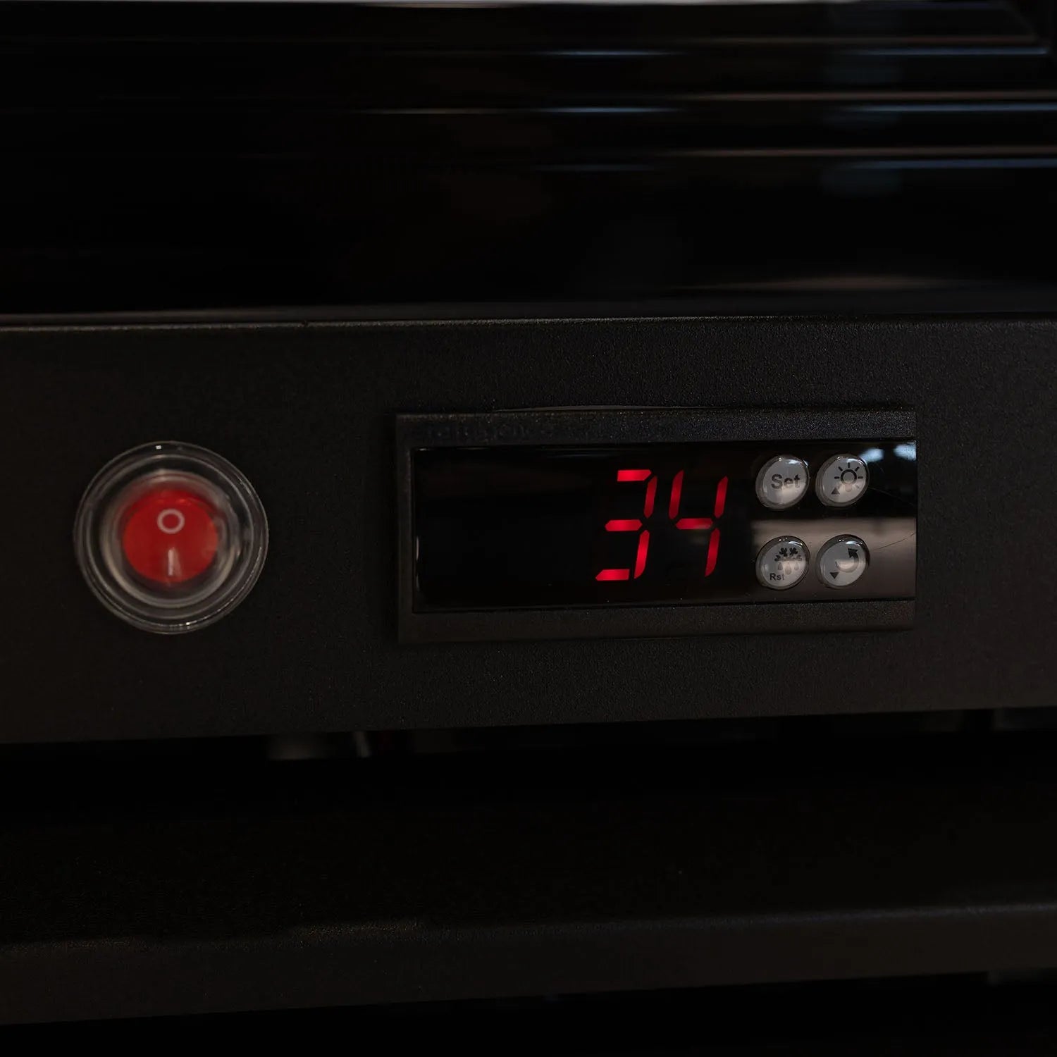 Digital temperature display on a black appliance with red numbers