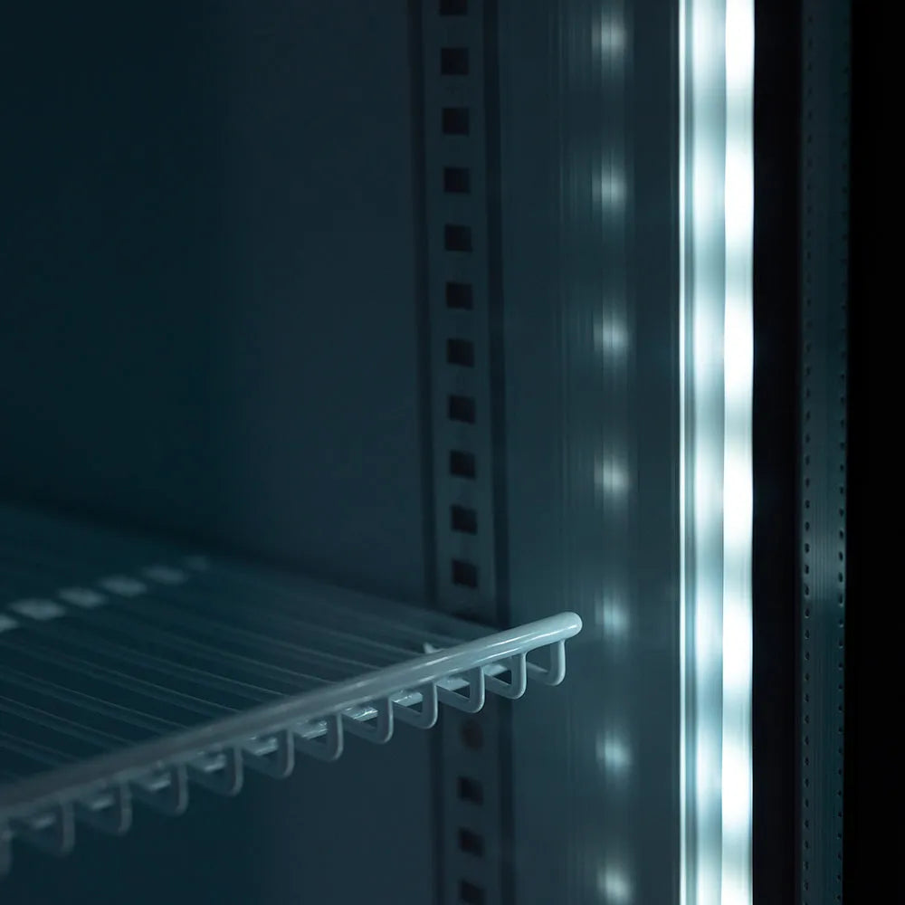 Close-up of a refrigerator door with a shelf inside, showing the interior design.