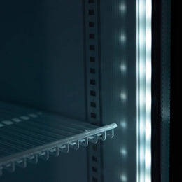 Close-up of a refrigerator door with a shelf inside, showing the interior design.