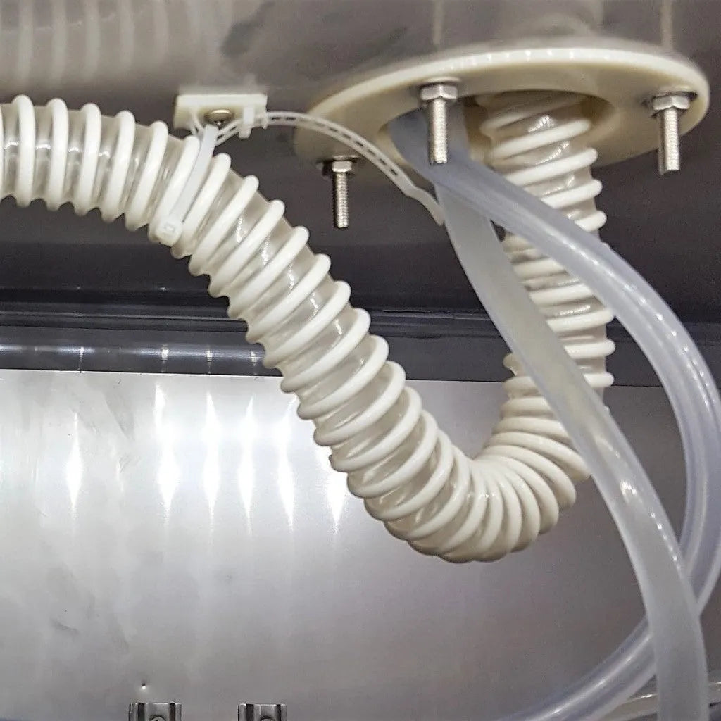 White flexible hose with connectors on a metallic surface