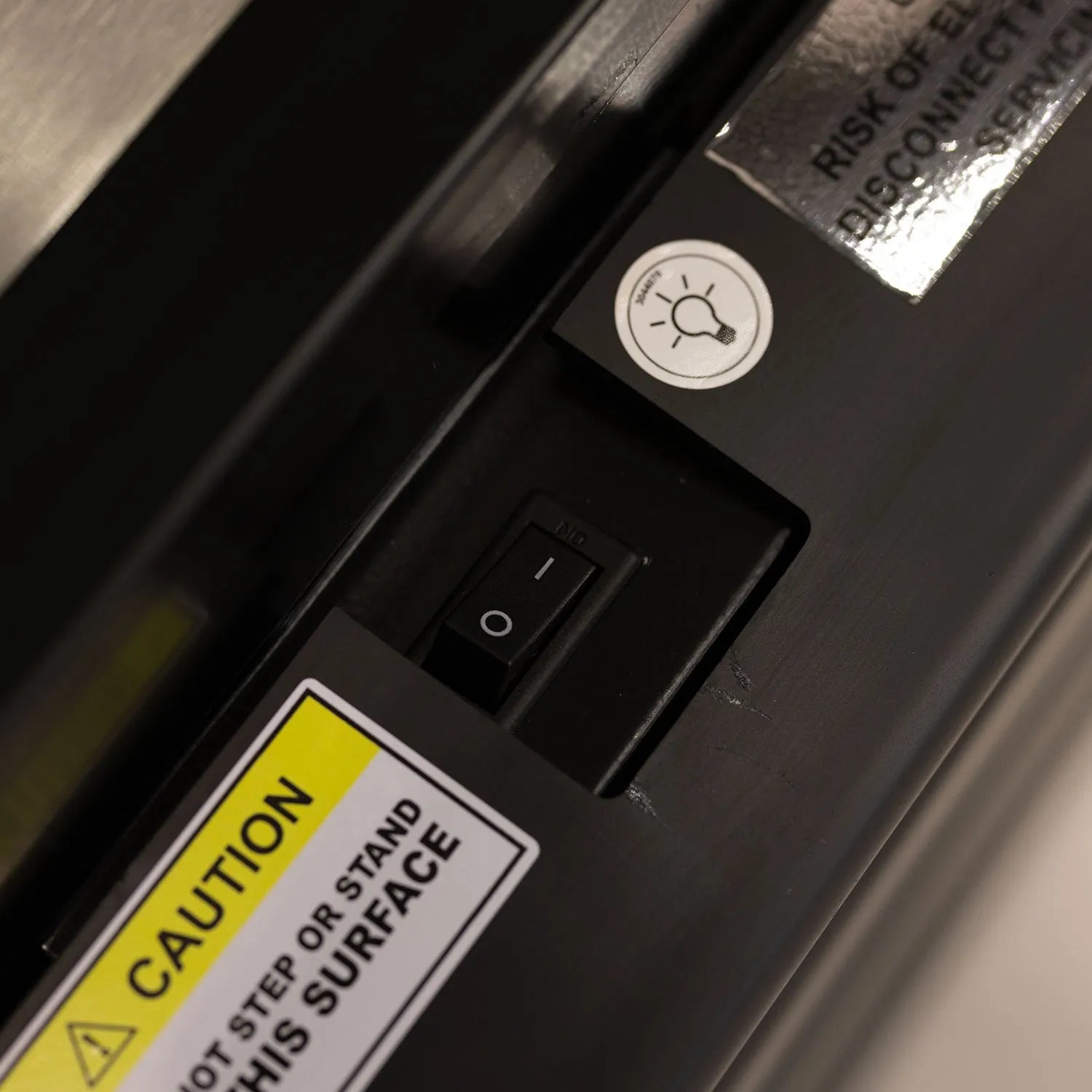 Close-up of a power switch and warning label 
