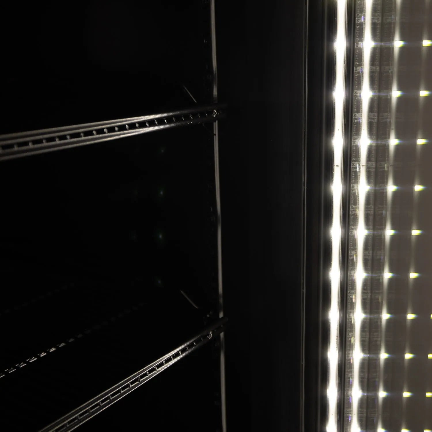 Close-up of a refrigerator door with LED light strip on a dark background
