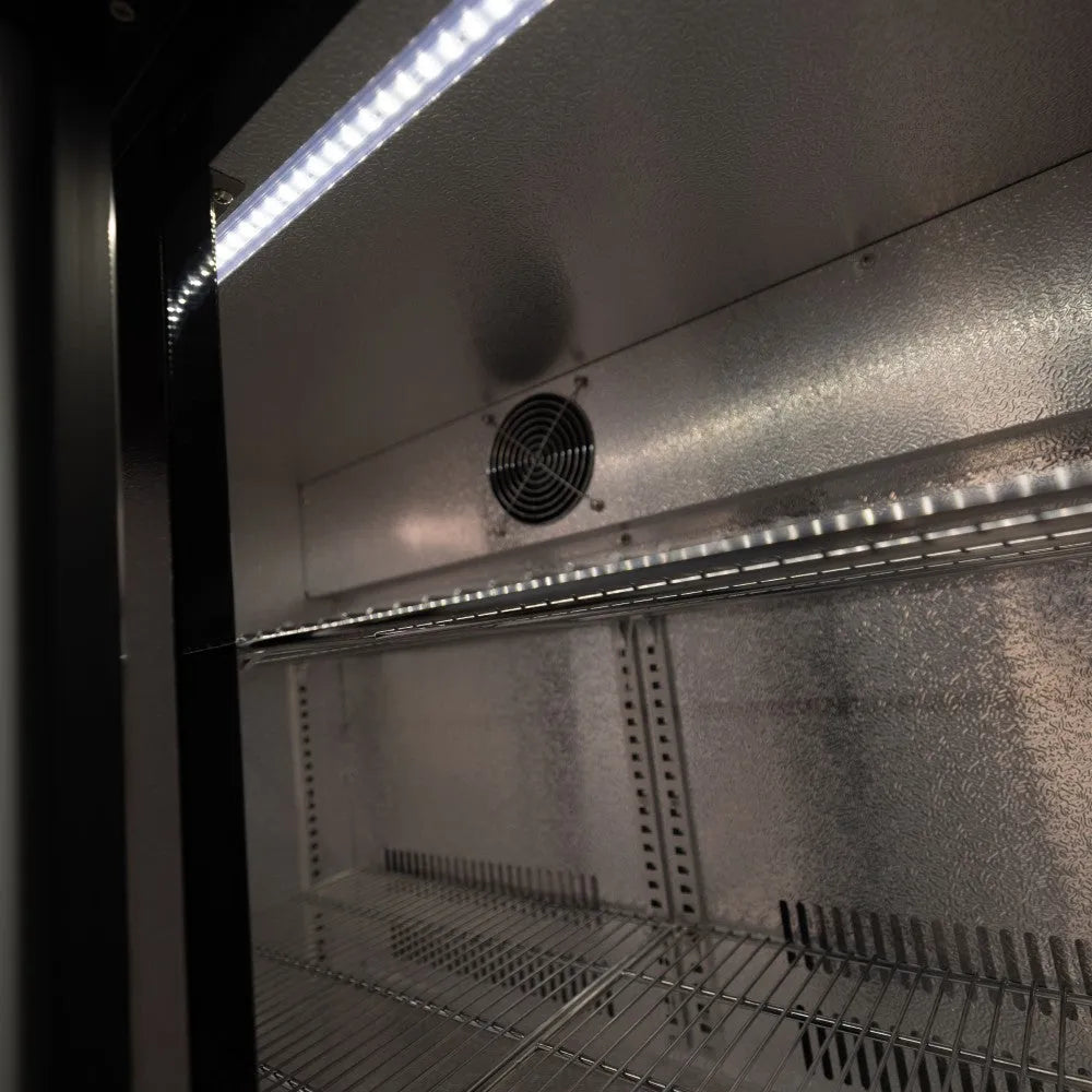 Empty refrigerator with interior shelves and light visible