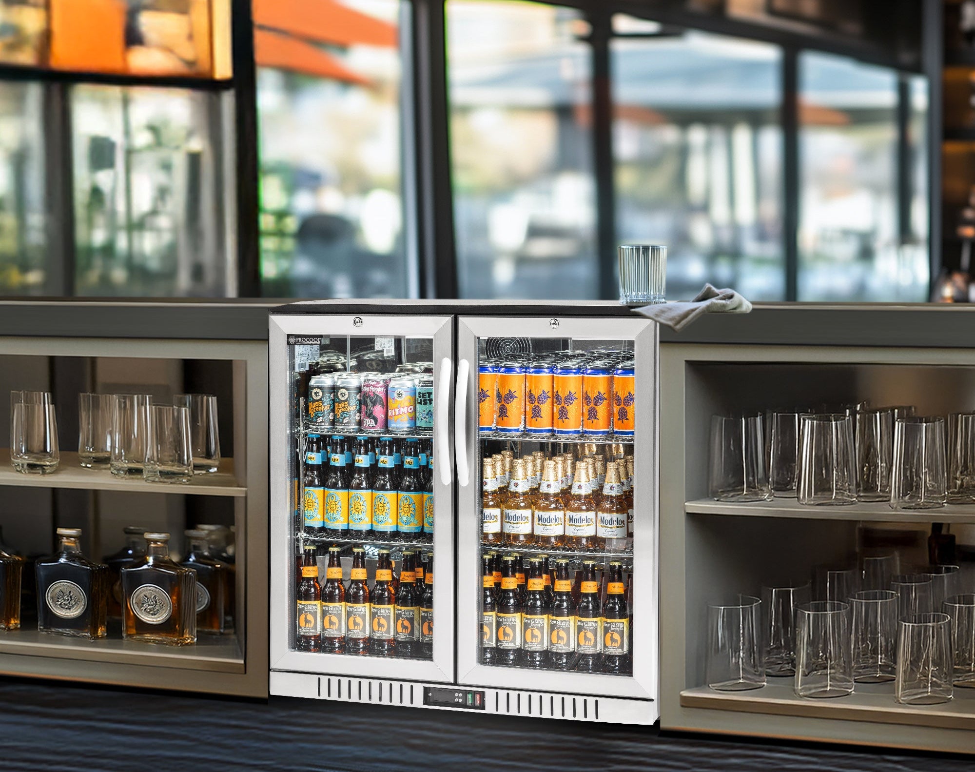 Beverage cooler with drinks and glasses in a bar setting