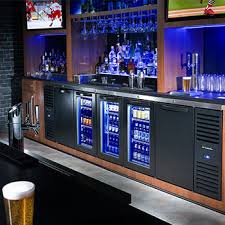 Modern bar setup with refrigerators, glasses, and bottles.