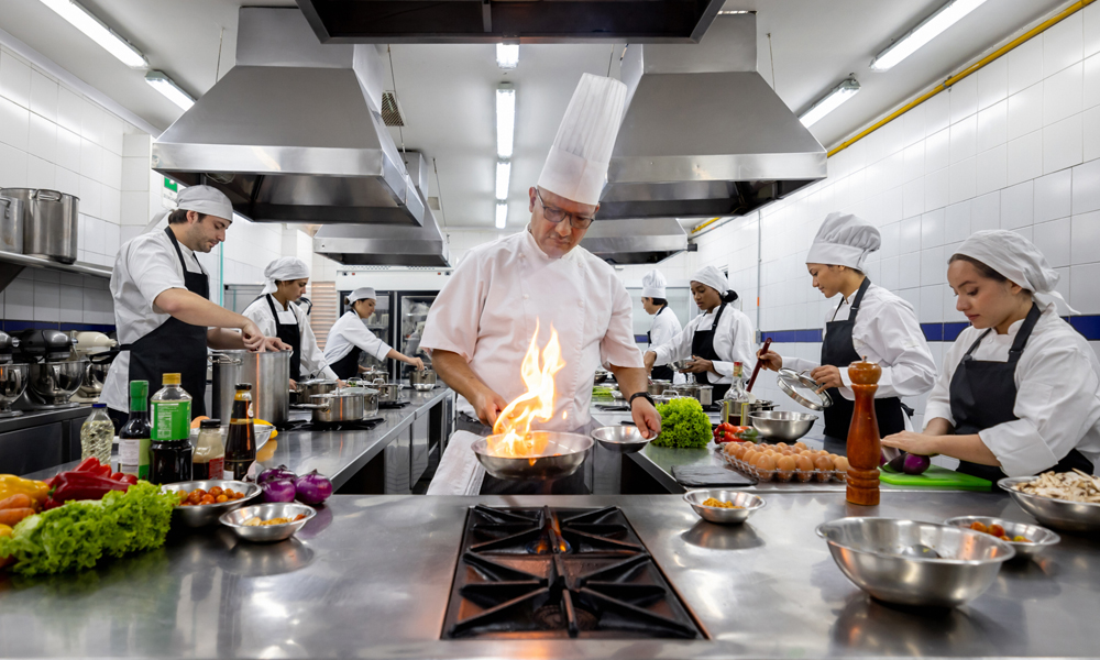 restaurant safety tips, image of working kitchen with flaming pan