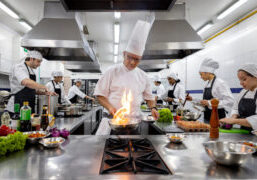 restaurant safety tips, image of working kitchen with flaming pan